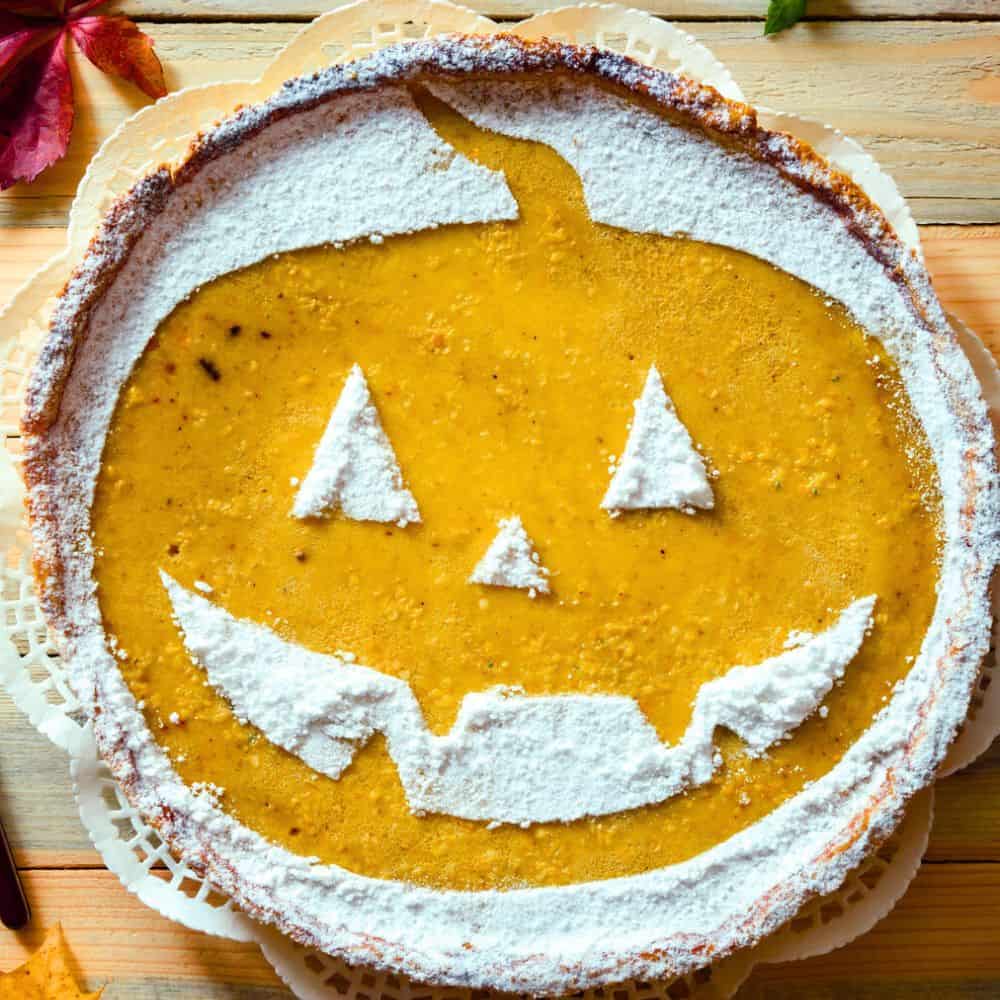 Cheater Halloween Pumpkin Pie - store bought pumpkin pie with a powder sugar jack o lantern face on top