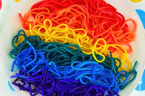 Colored Spaghetti Recipe on a plate top down view (rainbow pasta)