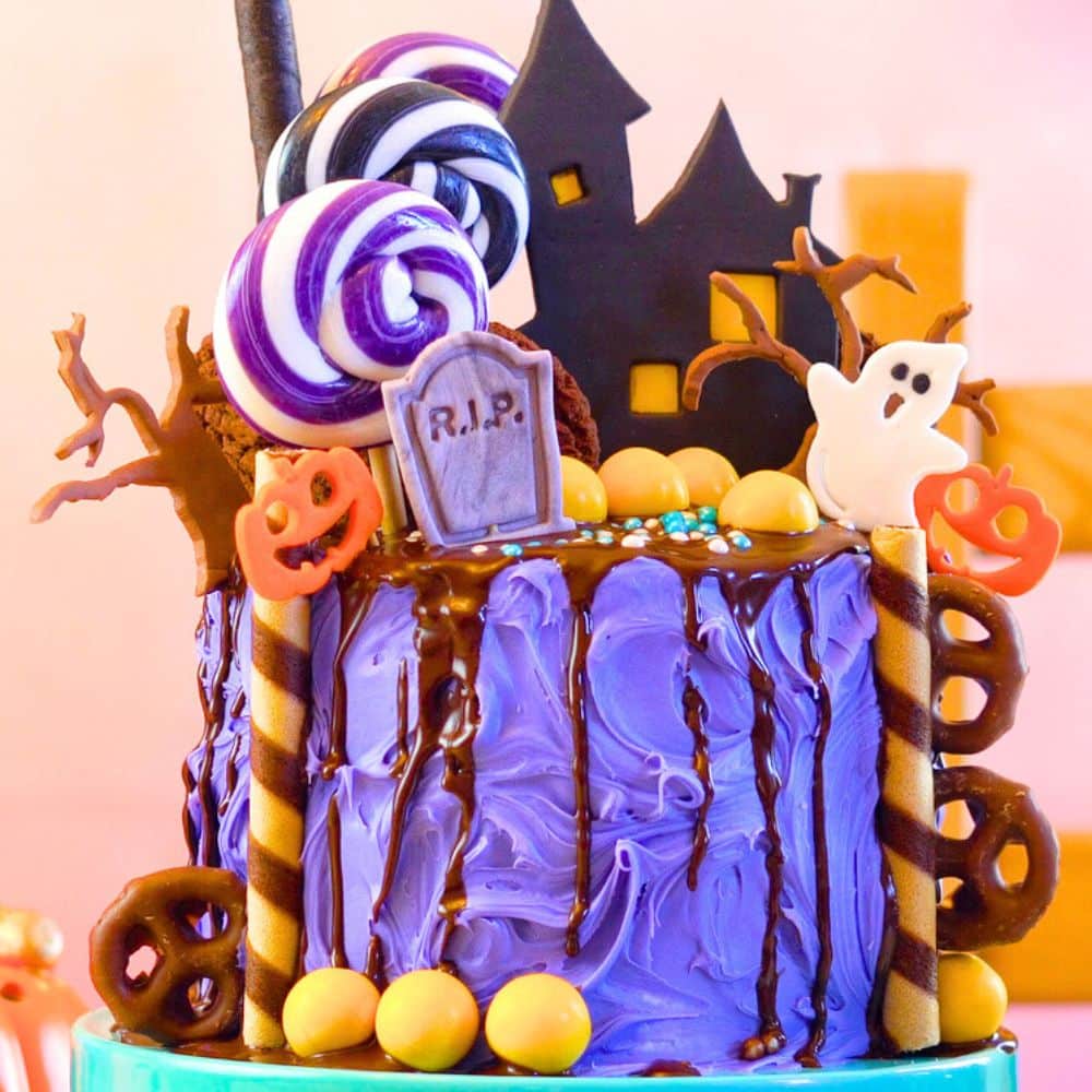 Easiest Halloween Cake Ever - store bought purple Halloween cake decorated with Halloween candy and Halloween food