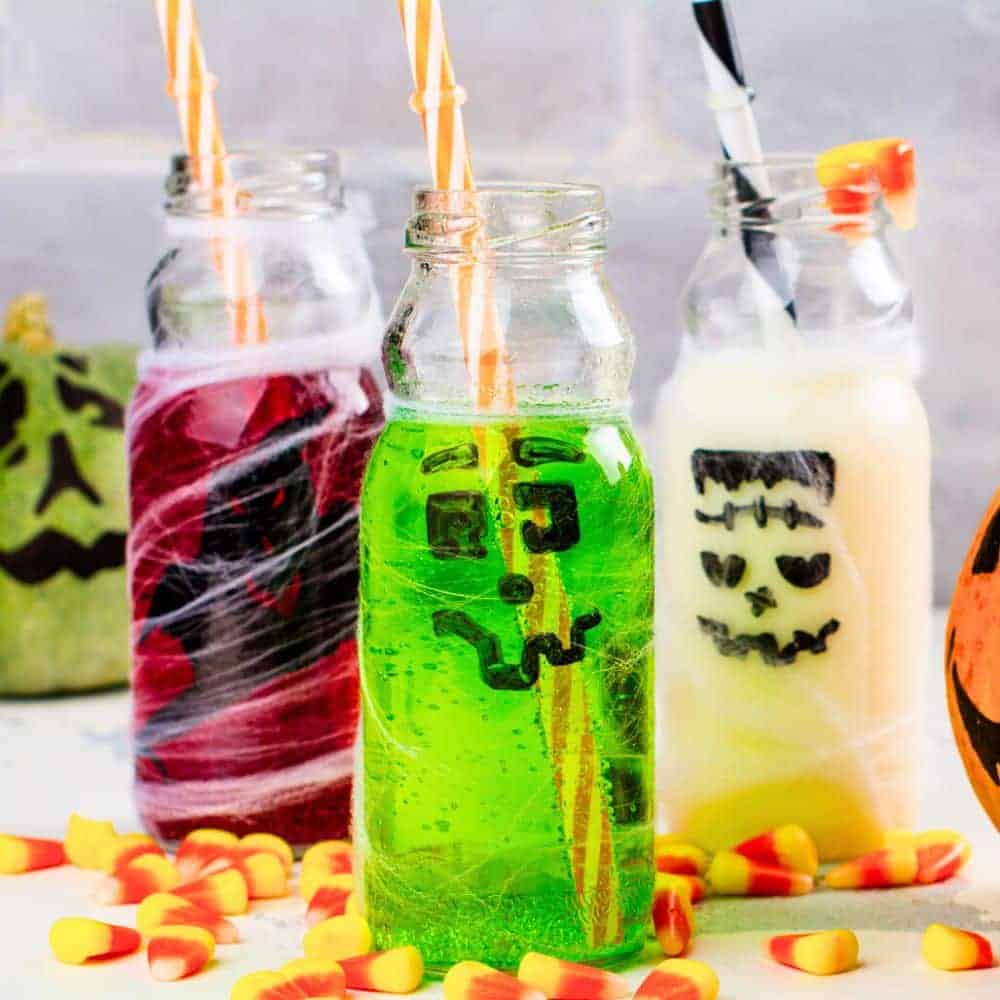 Easy Halloween Drink Ideas For Kids different color Halloween drinks with goofy faces on the glass