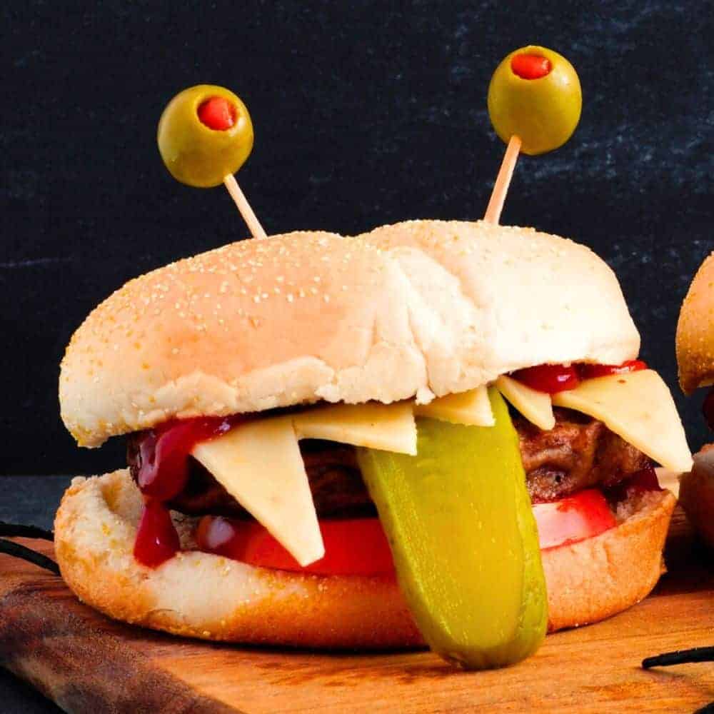 Easy Halloween Sandwich Ideas sub sandwich with a pickle tongue and olive eyes to look like a Halloween monster treat