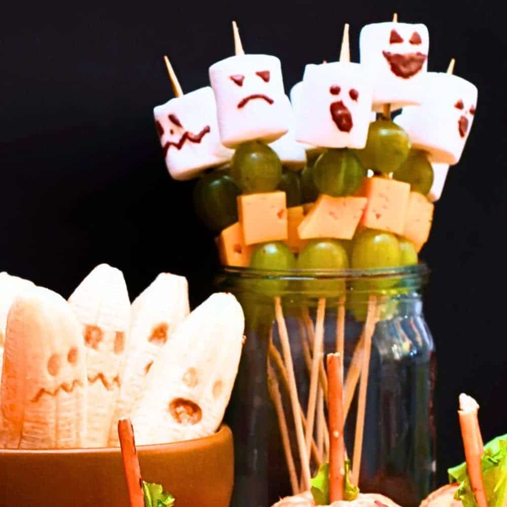 Ideas For Healthy Halloween Fruit Snacks For Kids ghost bananas and Halloween fruit skewers topped with ghost marshmallows
