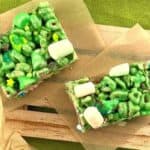 Lucky Charms St Patrick's Day rice krispies recipe on brown parchment paper sitting on green dishtowel