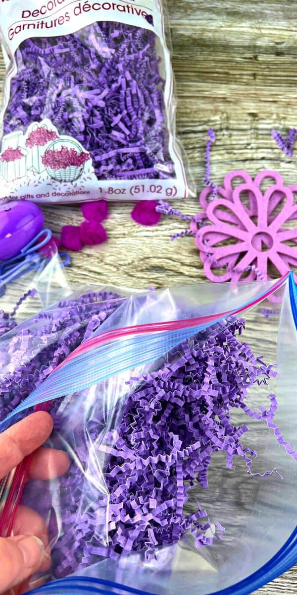 Using Fake Grass For Easter Baskets For Games hand on table making leftover Easter grass activity