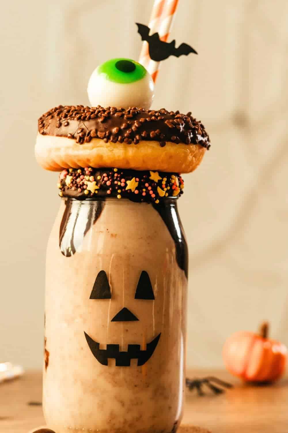 Breakfast Halloween Treat chocolate milk jar with melted chocolate around top and donut over a straw