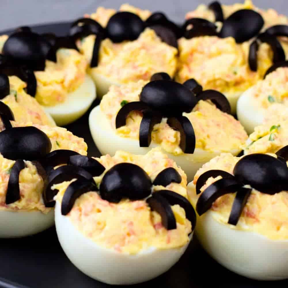Halloween Spider Eggs (Fun Halloween Foods) deviled eggs with black olives on top to look like spiders