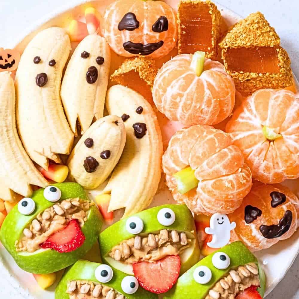 Healthy Halloween Fruit Plate different fruits with funny Halloween faces on them