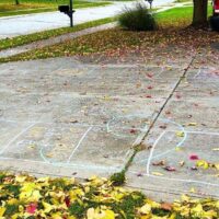 Halloween Hopscotch Game chalk hopscotch on a drive way with a teen dressed up as a vampire doing the Halloween hopscotch board outdoors