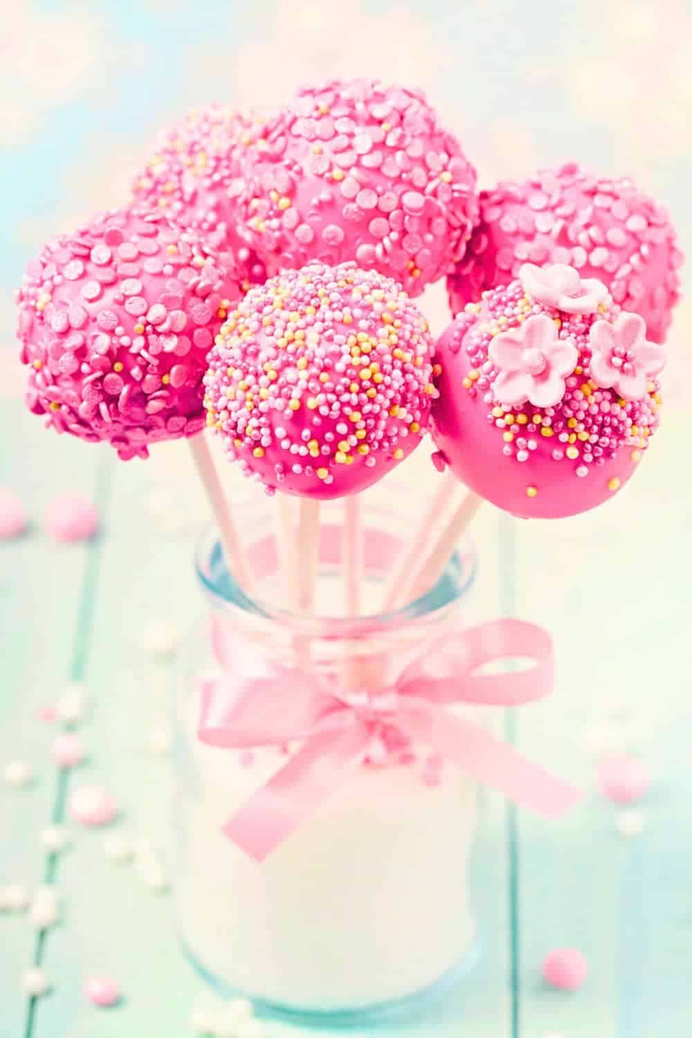 Pink Cake Pops For Barbie Parties hot pink cake pops standing up in a cute milk jar with a pink bow