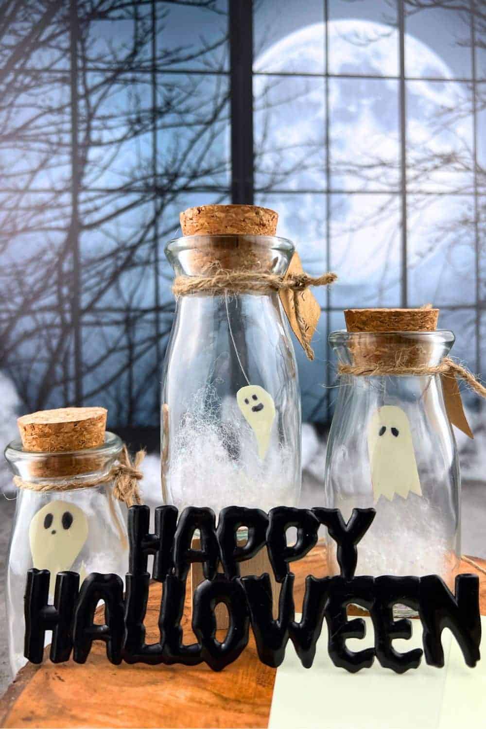 Little Boo Pet Ghost Floating Halloween Mini Ghost in a Glass Bottle with a Halloween moon behind them