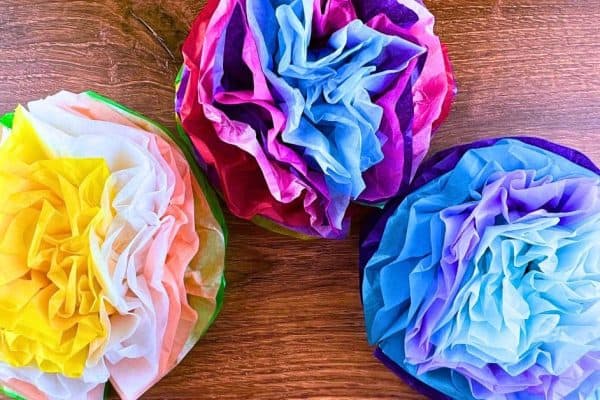 Easy DIY Tissue Paper Flowers Craft For Kids (Flower And Paper Kids Activities) - colorful Mexican paper flowers on a table