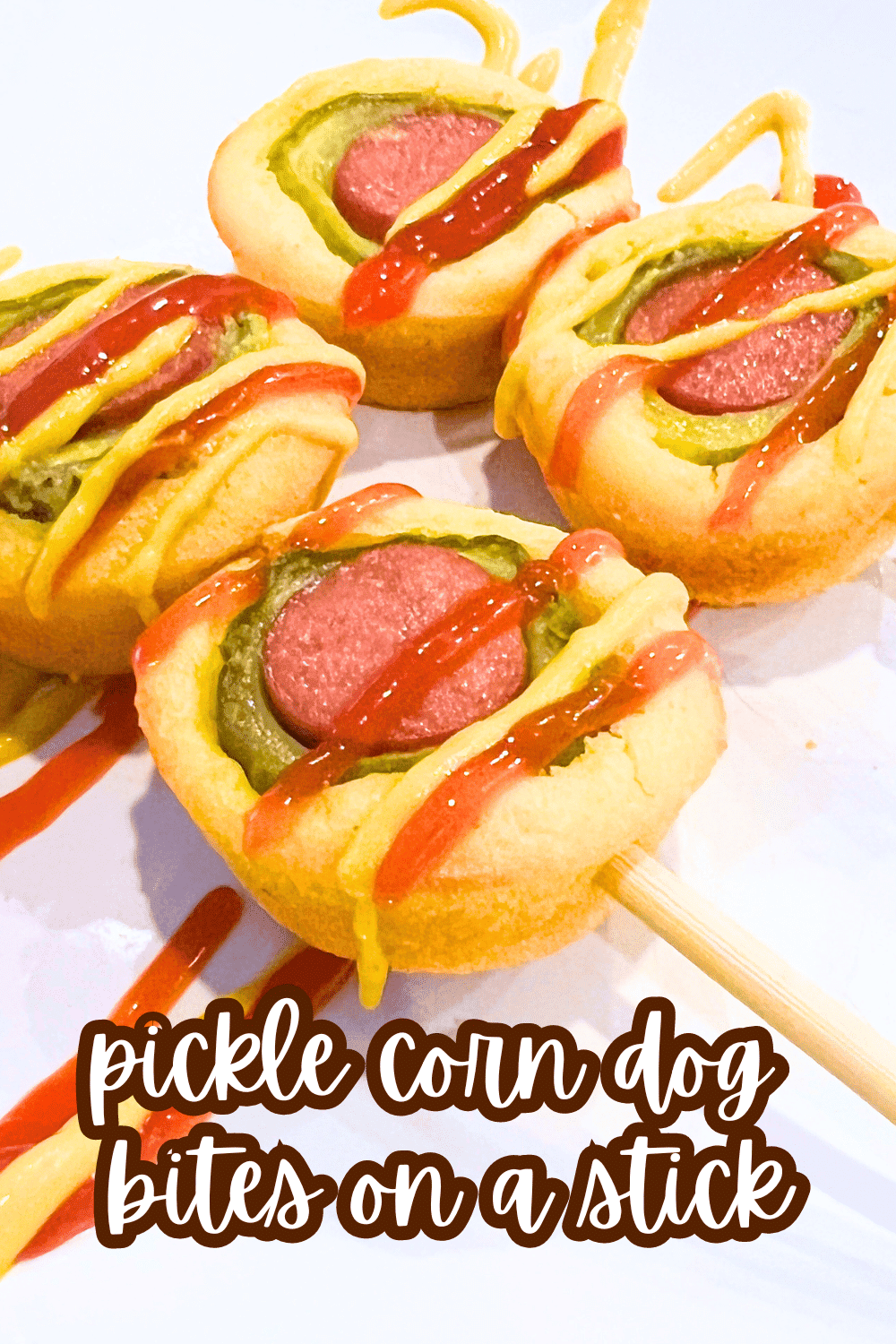 Easy Pickle Corndogs On A Stick (Dilly Dog Bites) text over a white plate with ketchup and mustard sauce on them