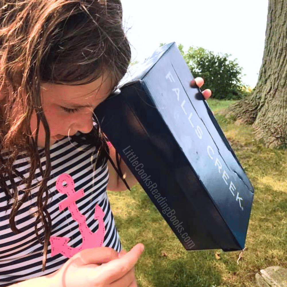 How to make a solar eclipse viewer from a shoebox - child looking through a pinhole eclipse viewer box