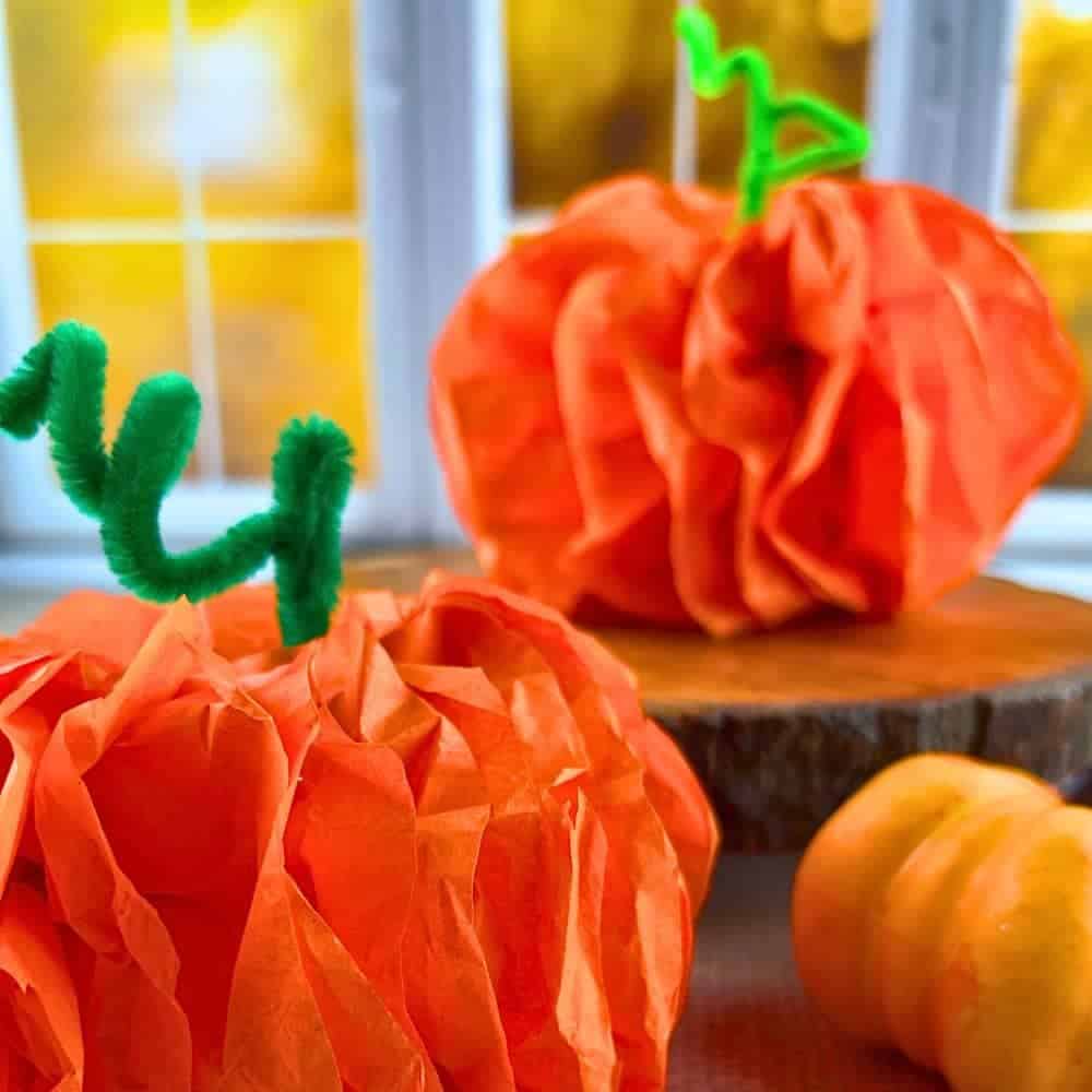 Tissue Paper Pumpkins Easy Craft For Kids Activities For Fall cute tissue paper pumpkin crafts sitting on a table in front of a fall window