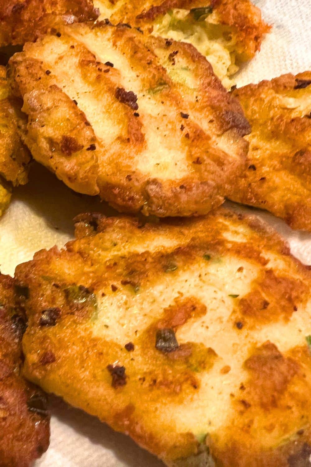 Leftover Mashed Potato Pancakes Recipe for Holiday Leftovers - close up of fried potato cakes on a white plate