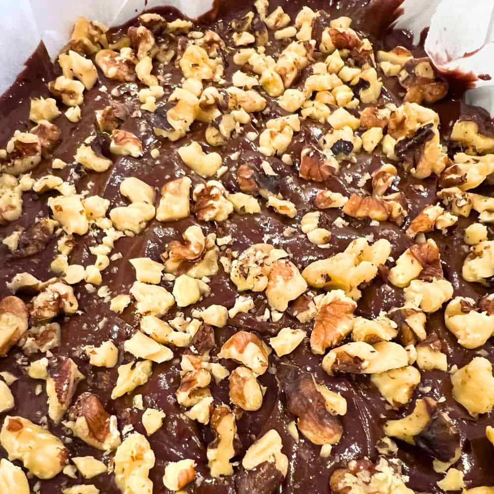 2 Ingredient Peanut Butter Chocolate Fudge Recipe - picture of chocolate peanut butter fudge with nuts on top in a pan