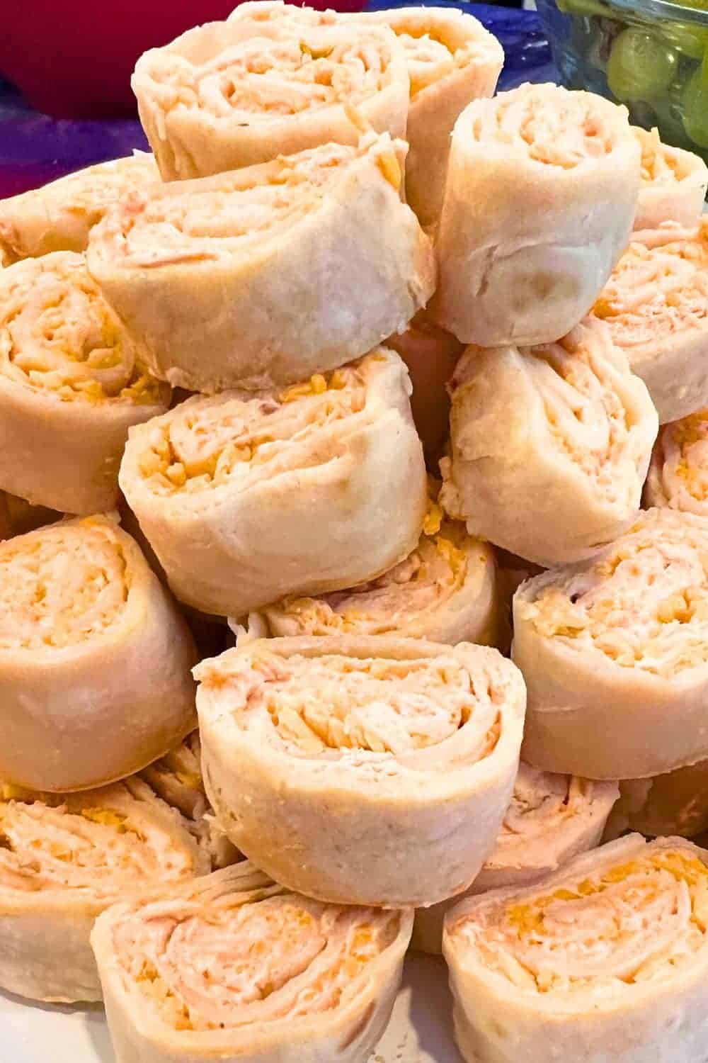 Fiesta Taco Pinwheels (Mexican Cheese Roll Ups) stacked up on a white plate