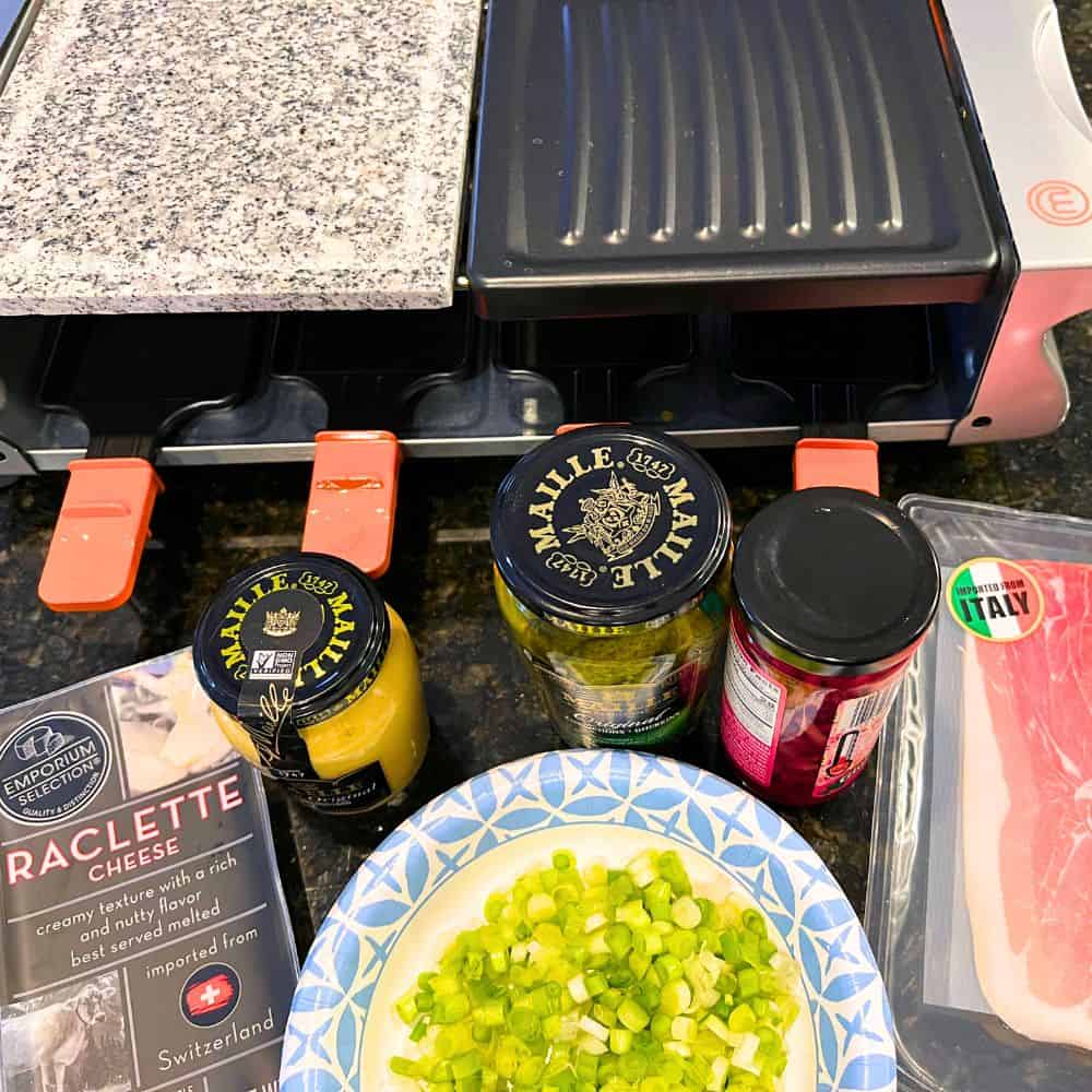 How To Make Raclette At Home (Raclette Ingredients and raclette maker on a counter)