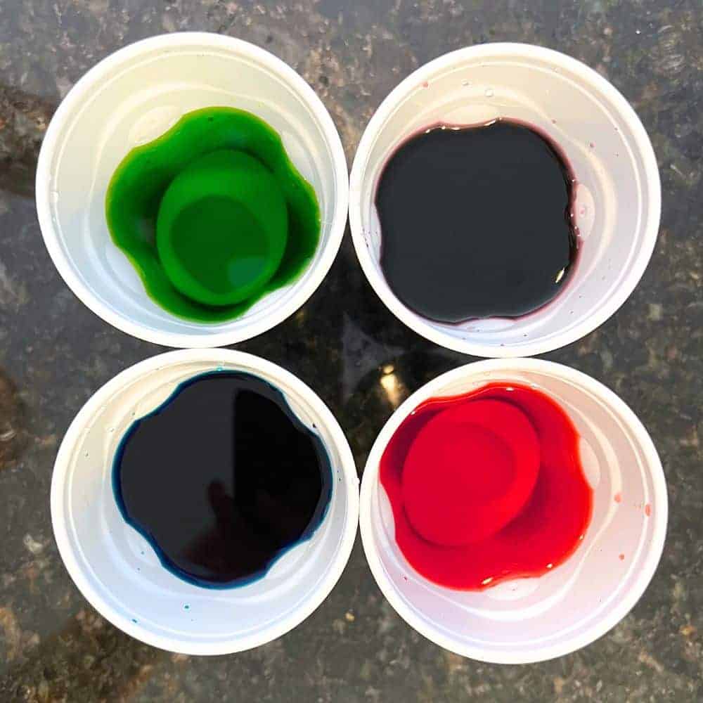 Making Dyed Deviled Egg Recipe top down image of egg whites dyeing in cups