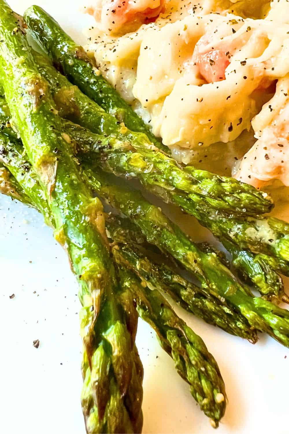 Quick Air Fried Asparagus Recipes on a plate with chicken and noodles