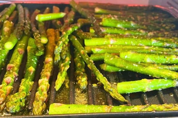 Quick And Easy Air Fryer Roasted Asparagus With Parmesan on a baking pan in an air fryer oven