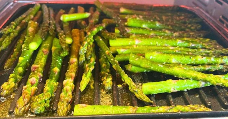 Quick And Easy Air Fryer Roasted Asparagus With Parmesan on a baking pan in an air fryer oven