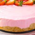 Easy Strawberry No Bake Cheesecake Dessert on a pie plate with fresh strawberry slices on top