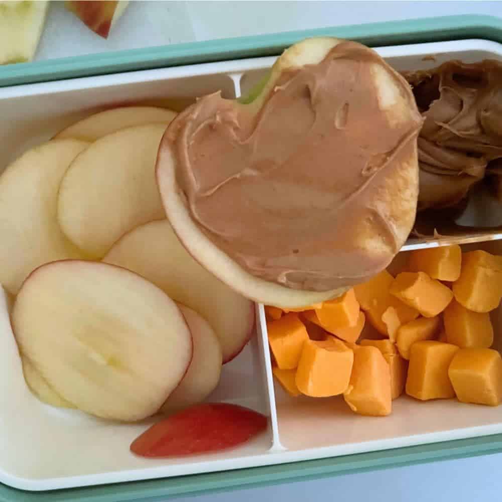 Easy Bento Lunch Box Ideas For Kids - apple and peanut butter snack box with cheese cubes, cut apple slices and peanut butter in a bento box