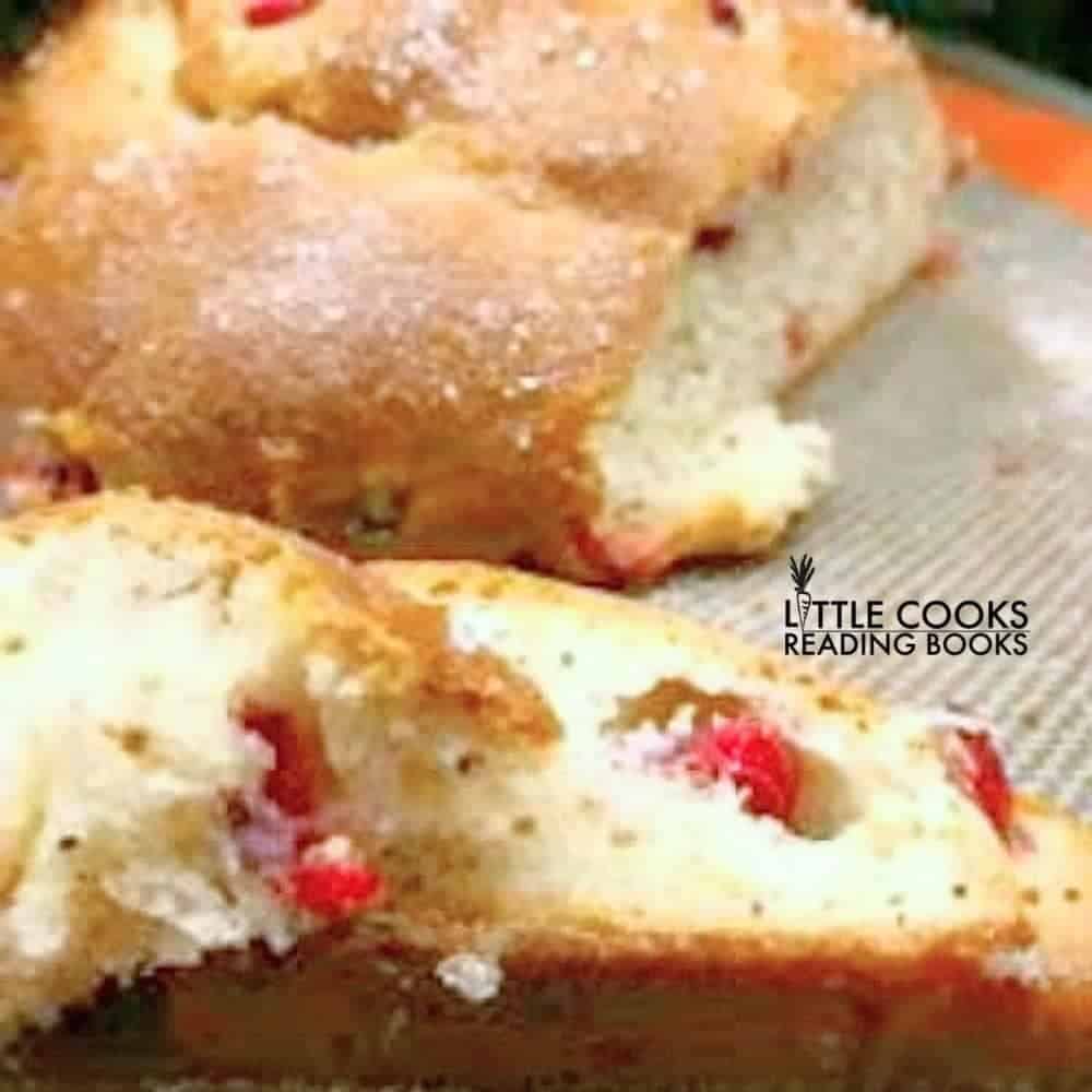 How To Make Homemade Pan de Muerto With Cranberries - DAY OF DEAD BREAD SLICED OPEN ON A BAKING SHEET