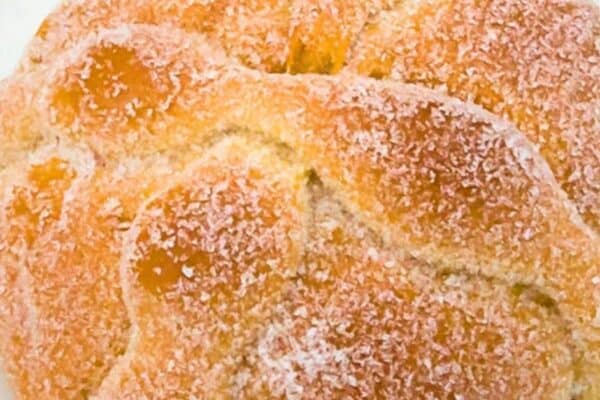 Mexican Day Of The Dead Bread Recipe Homemade Pan de Muerto With A Twist -Dia de los Muertos bread on a white plate