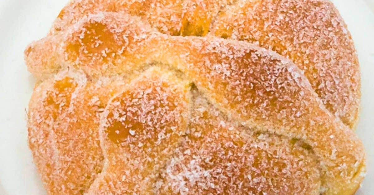 Mexican Day Of The Dead Bread Recipe Homemade Pan de Muerto With A Twist -Dia de los Muertos bread on a white plate