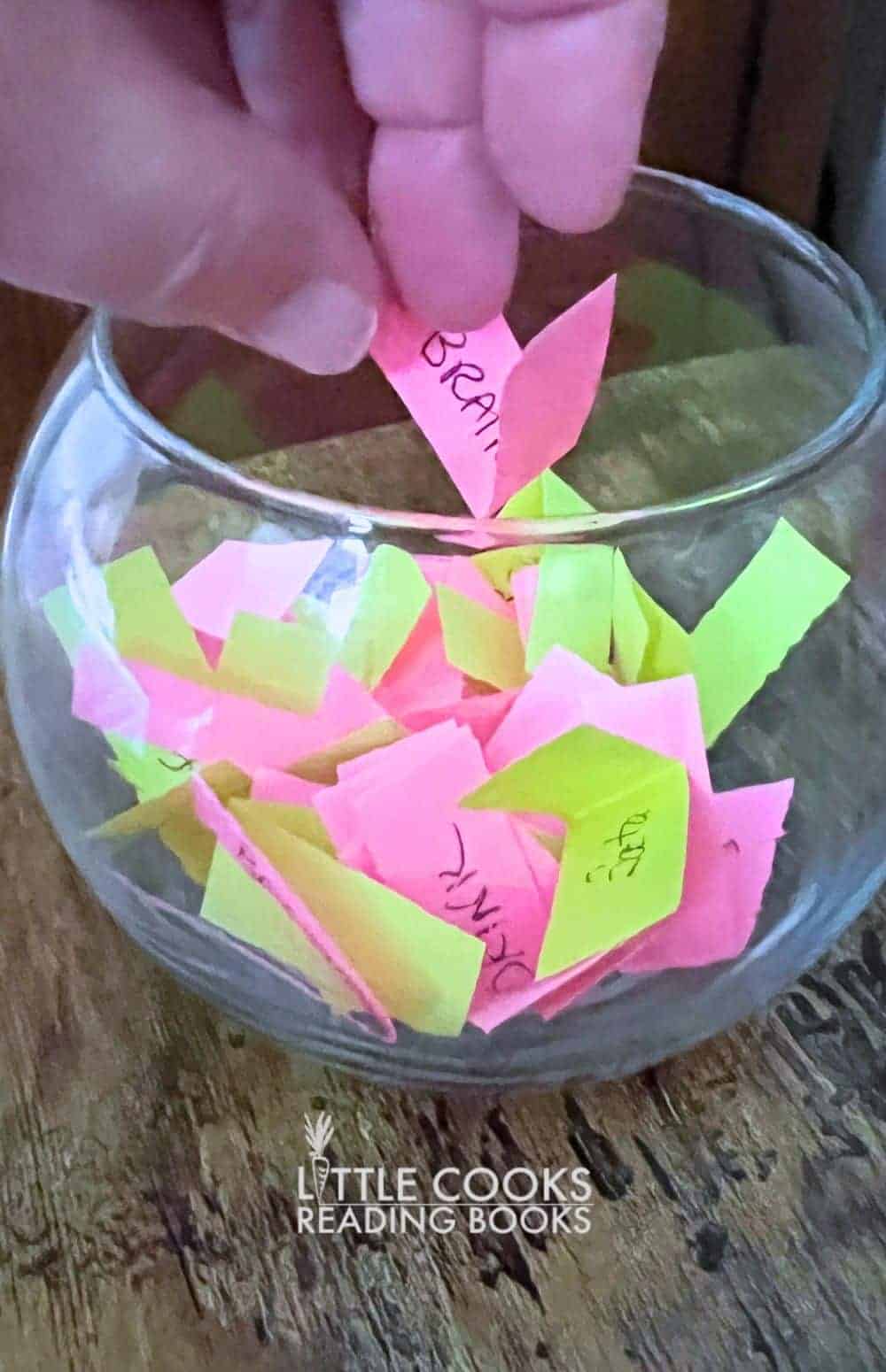 Fishbowl Game Ideas for Family Group Games Fun Activities and Game Night - hand reaching into a fish bowl game for game clues