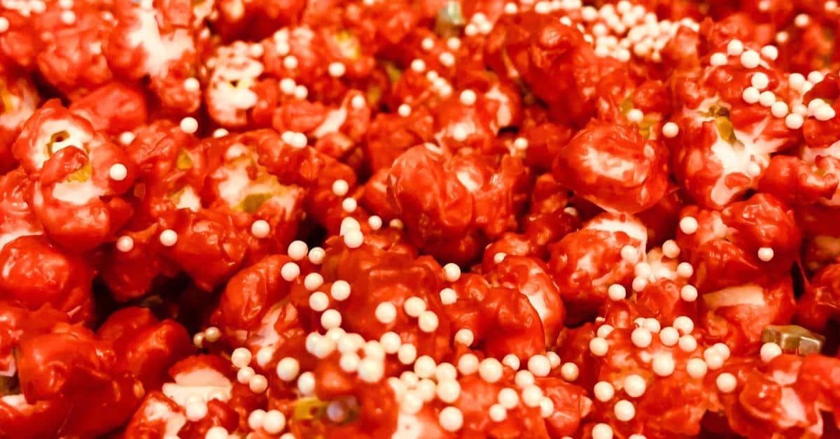 Christmas Popcorn Recipes For Easy Holiday Treats - red Christmas popcorn recipes with white sprinkles for DIY Christmas party snacks, Christmas movie night popcorn or DIY homemade Christmas food gifts