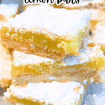 lemon squares stacked on top of each other on a party platter with text overlay homemade lemon bars recipe