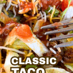 classic taco salad recipe with tortilla chips in a bowl with a fork
