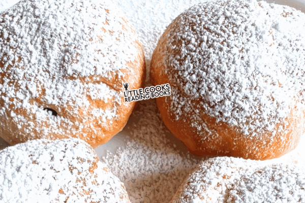 fake beignets recipe made with biscuits and powdered sugar on a plate