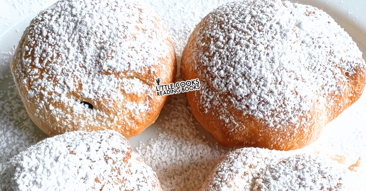 fake beignets recipe made with biscuits and powdered sugar on a plate