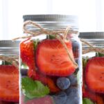 Strawberry Infused Water Recipe in a mason jar with straw for party drinks