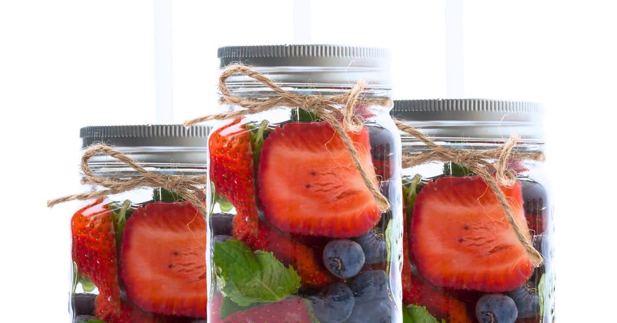 Strawberry Infused Water Recipe in a mason jar with straw for party drinks