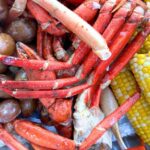 seafood boil recipe with crab, potatoes, corn and shrimp on a serving platter