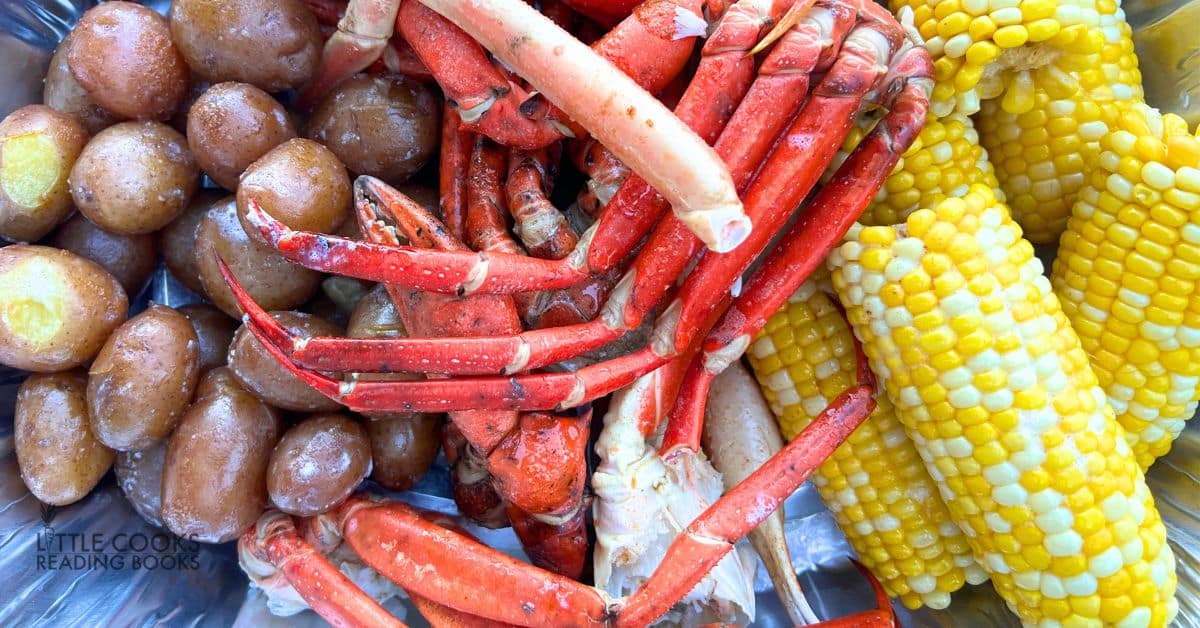seafood boil recipe with crab, potatoes, corn and shrimp on a serving platter
